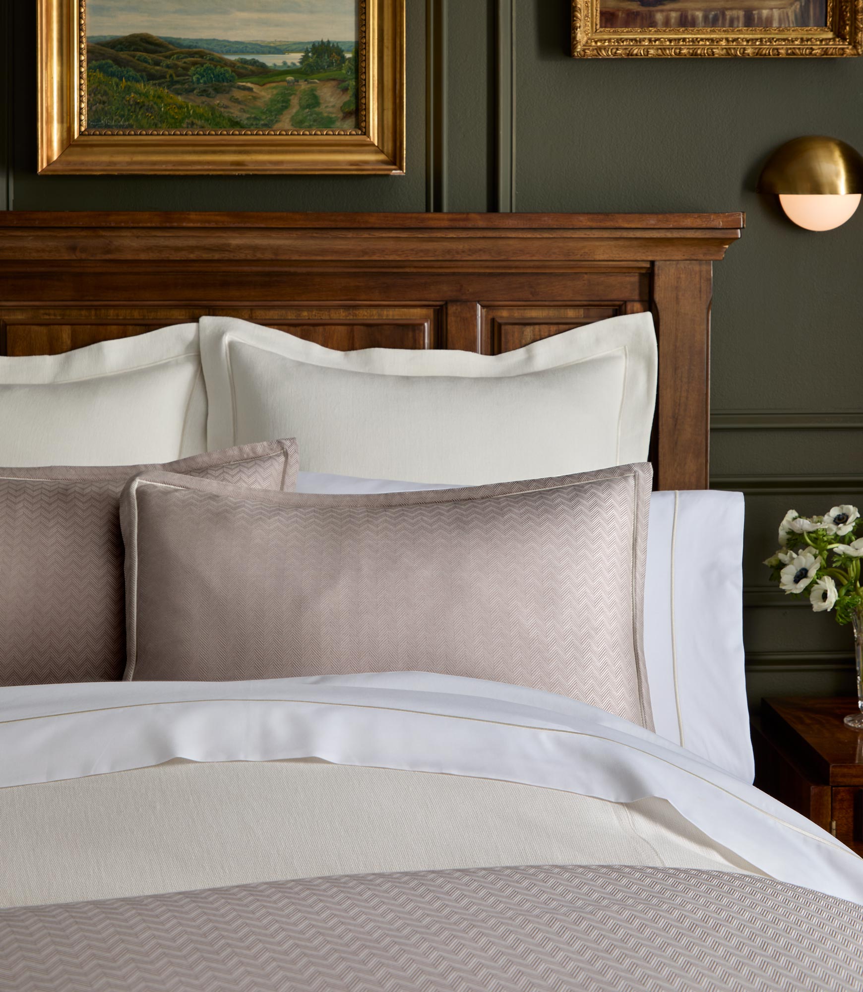Savoy Jacquard Duvet and Sham styled on a bed with a wooden headboard, Platinum