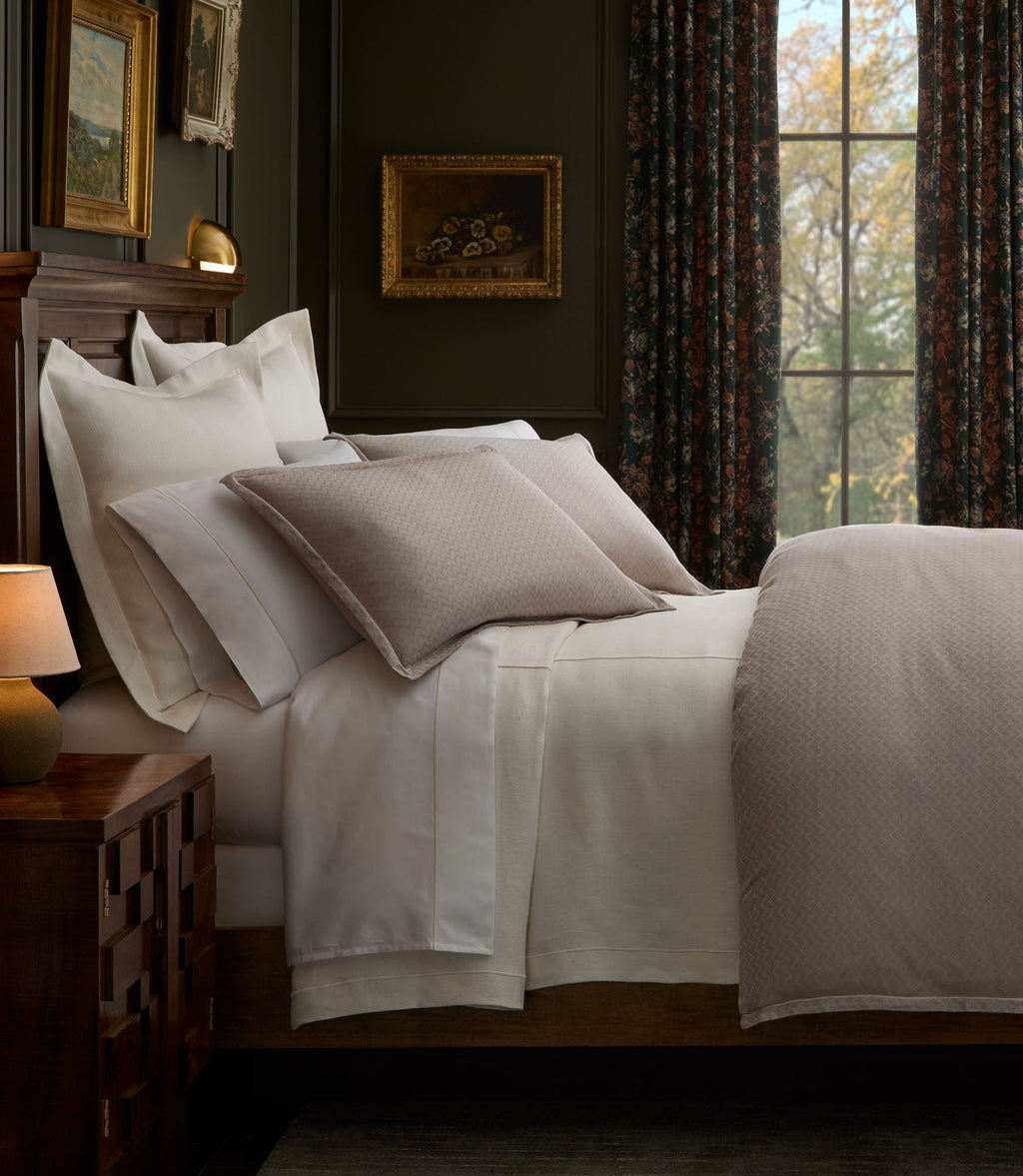 Savoy Jacquard Duvet and Shams on a bed in a moody bedroom, Platinum