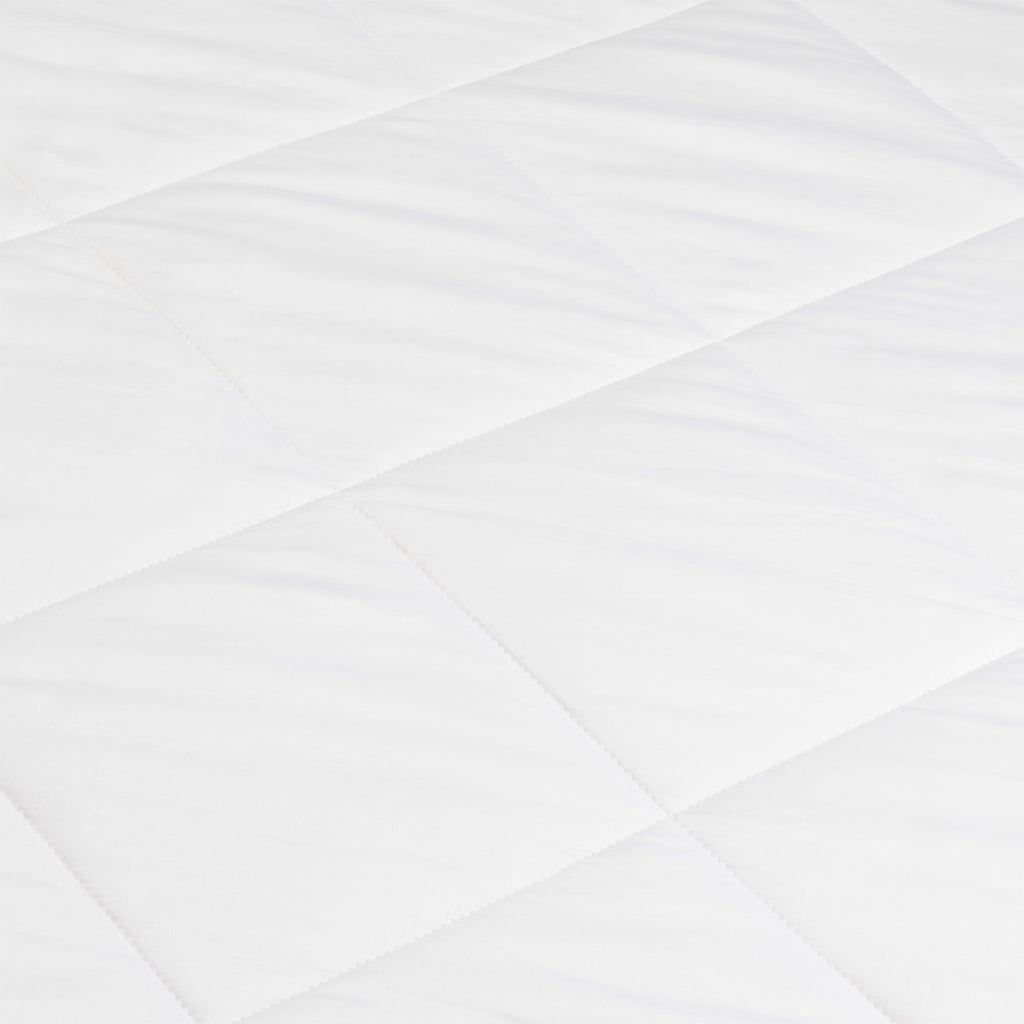 A close-up of the Cozy Earth Bamboo Viscose Comforter shows its smooth, soft white quilted fabric with a diamond pattern formed by intersecting stitched lines.|Filling:Extra